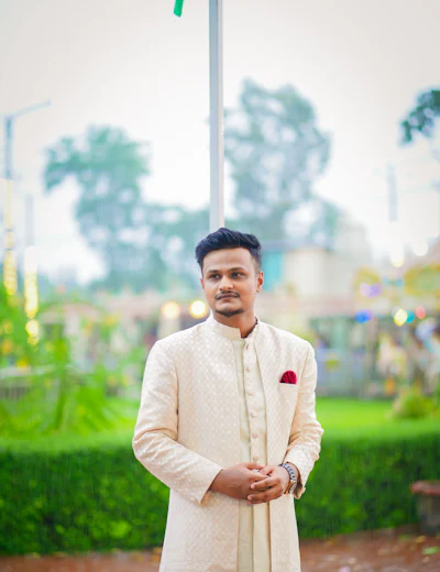 Groom in an ivory sherwani in a garden