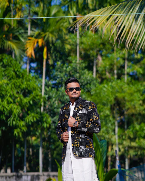 Man in a patterned Indo-Western jacket over a white kurta