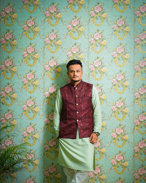 Man in an embroidered koti over a kurta set