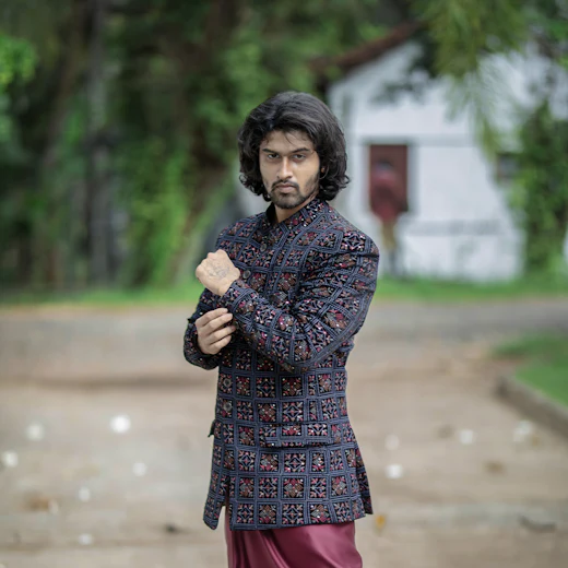 Man in an embroidered Indo-Western outfit