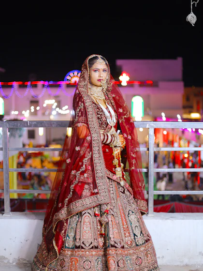 Bride in an embroidered red wedding lehenga with dupatta